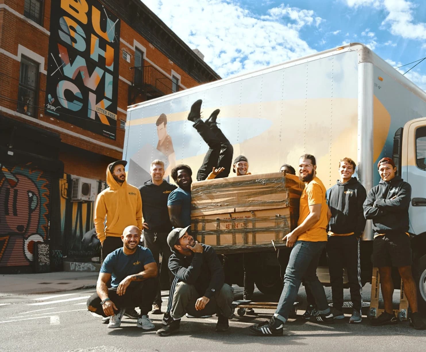 Team of movers posing with furniture